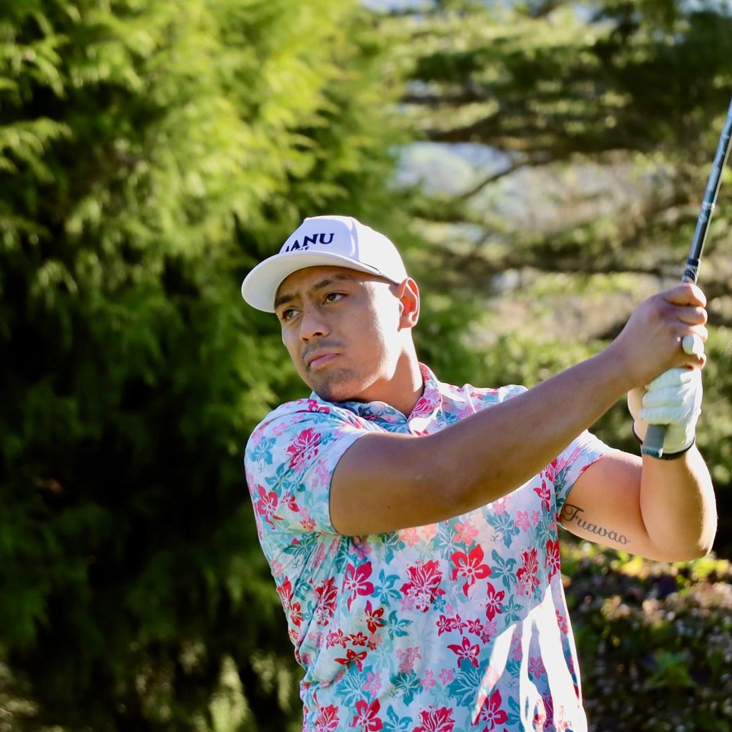Island Bloom Polo shirt in light blue, featuring Polynesian-inspired patterns for a stylish golf look. Proudly designed in New Zealand.