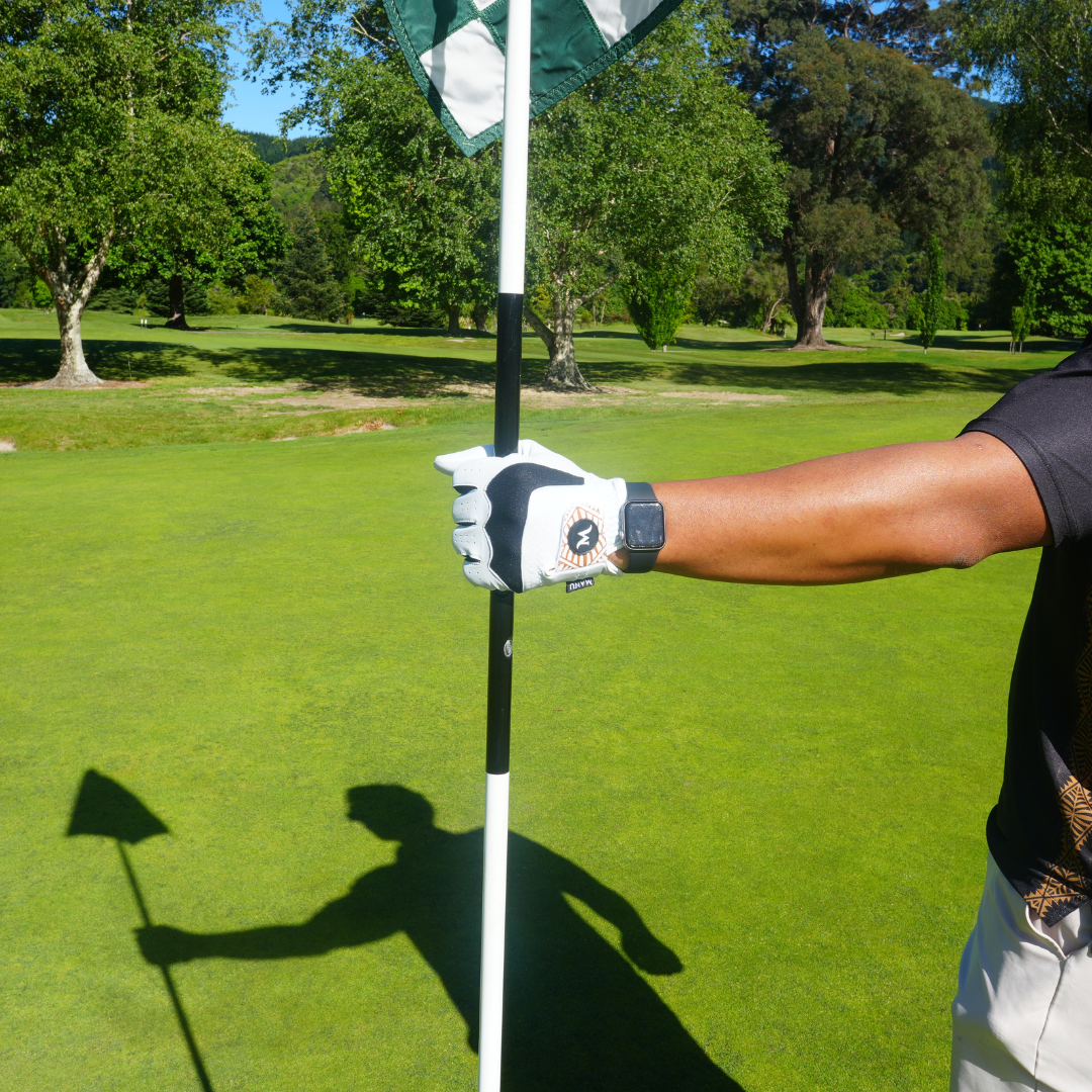 Golfer wearing White Manu Golf glove, designed for optimal grip and comfort during play. Proudly designed in New Zealand.