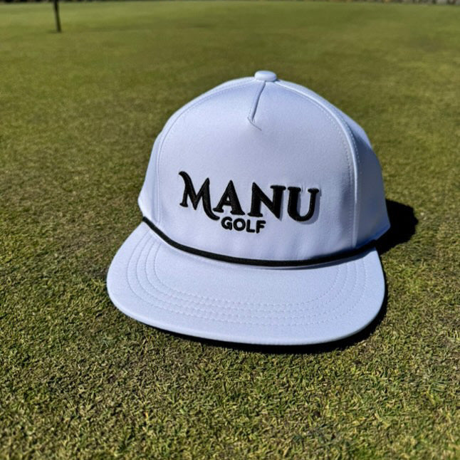 Manu Golf hat on green grass, showcasing stylish design and comfort for golfers and enthusiasts.