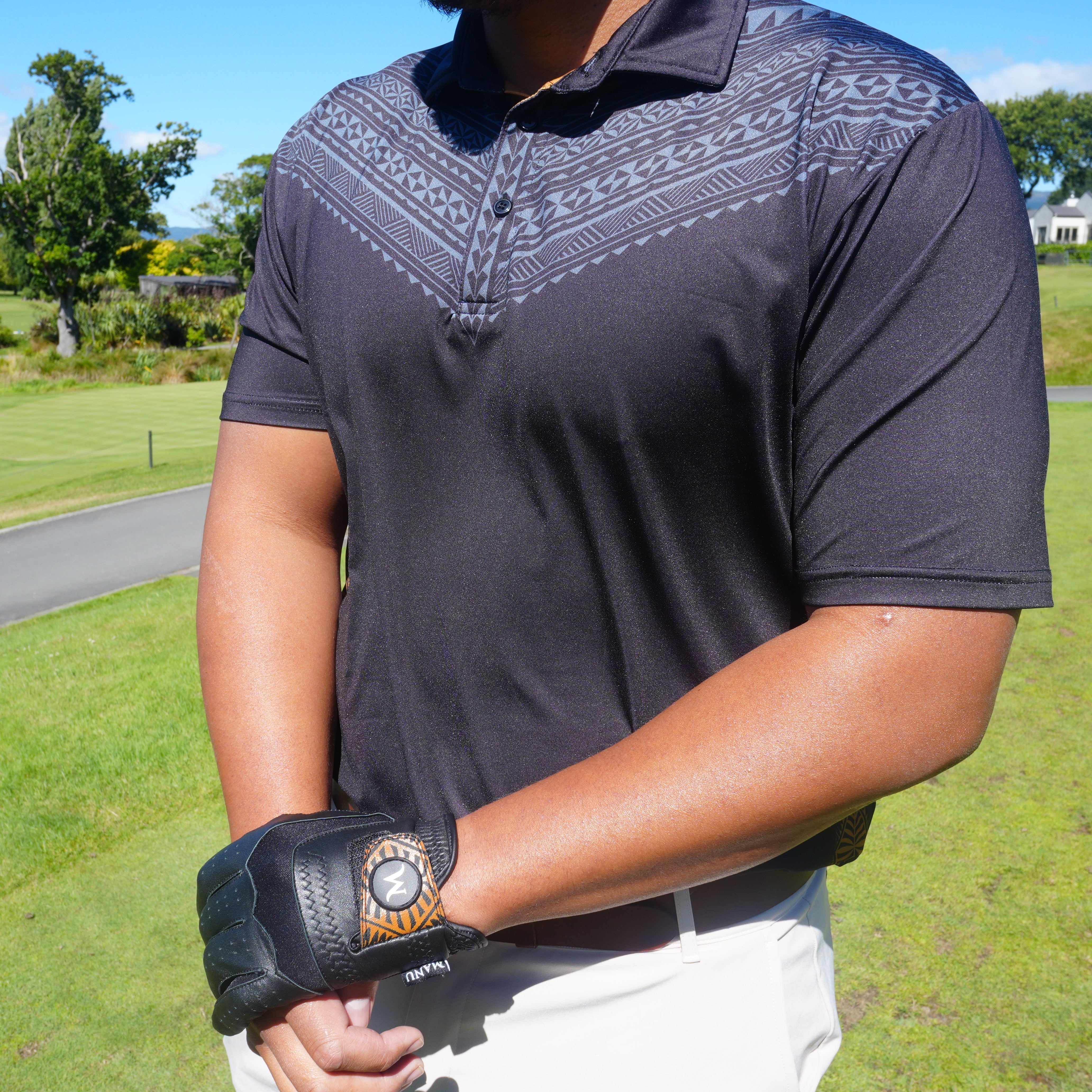 Heritage Golf Polo in black, showcasing Polynesian design, ideal for comfortable golfing performance.