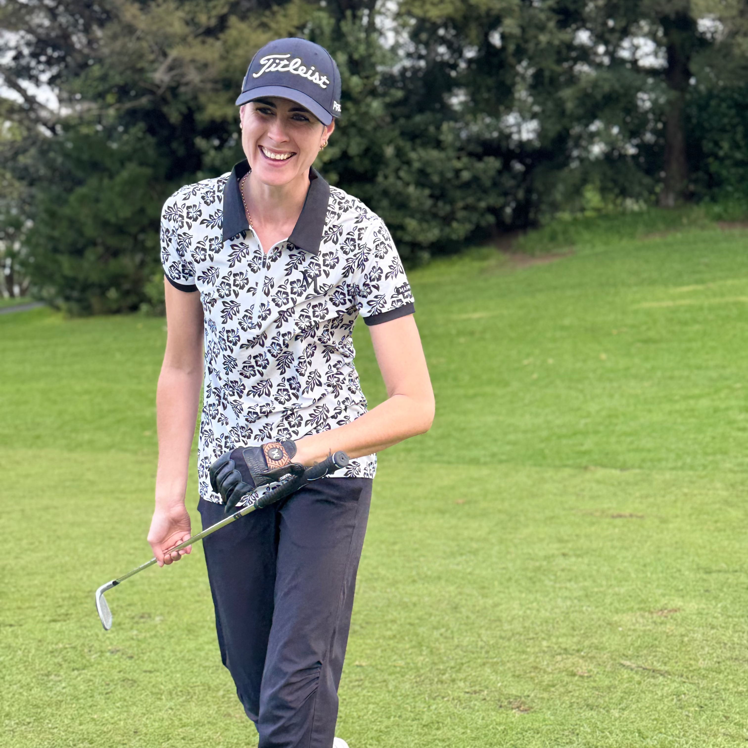Island Grace Women’s Golf Polo – White with Black Frangipani featuring Polynesian-inspired patterns for a stylish golf look. Proudly designed in New Zealand.